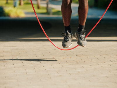 Jumping sportsman Feet of sportsman jumping with skipping rope