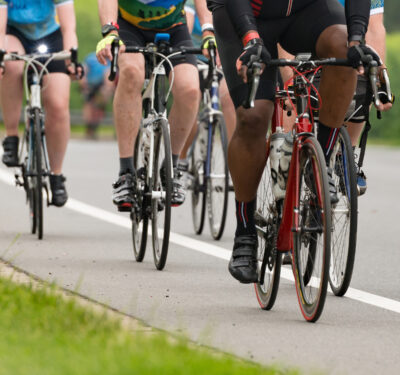 Group of cyclists competing in a race cropped square with a shallow depth of field and copy space Group of cyclists competing in a race cropped square with a shallow depth of field and copy space